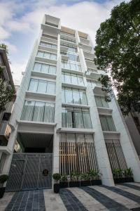 a tall white building with a lot of windows at The Royal Palace Uttara in Dhaka