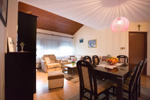 a dining room and living room with a dining table at Apartman Belin Ogulin in Ogulin