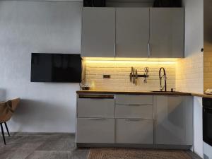 a kitchen with stainless steel cabinets and a sink at Batumi View apartment in Kachretʼi