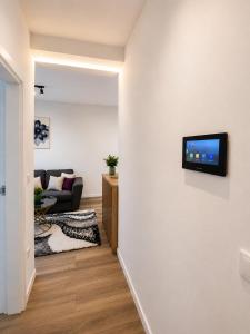 a living room with a tv on a wall at Urban Nest Tuzla in Tuzla