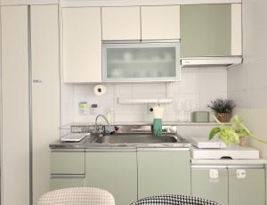 a kitchen with white cabinets and a sink at Mignon Stay FreeParking Near KSPODome AsanMedicalCenter LotteWorldTower in Samgong