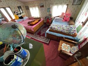 a small room with two beds and a table at Y Not Sonada in Sonāda
