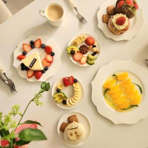 a table topped with plates of fruit and pastries at Mignon Stay FreeParking Near KSPODome AsanMedicalCenter LotteWorldTower in Samgong +29 photos