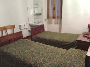 Voodi või voodid majutusasutuse Albergo Cervo toas