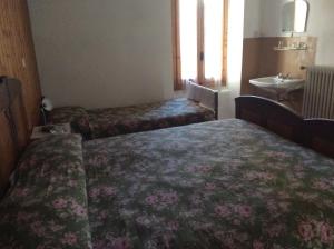 Voodi või voodid majutusasutuse Albergo Cervo toas