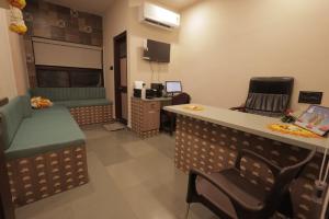 a waiting area of a waiting room with chairs and a counter at Hotel Best Inn in Valsād