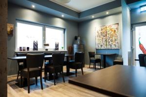 a dining room with a table and chairs at Hotel Nacht-Quartier in Willich +28 photos