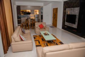 a living room with two couches and a table at Celanika resort in Kandy
