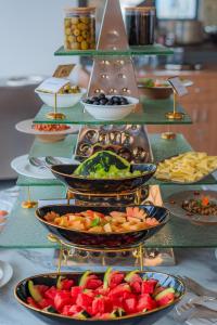 a buffet with many plates of food on a table at Hotel Sampada Boutique in Pokhara +88 photos