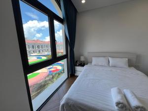 a bedroom with a bed and a large window at Arcadia homestay in Phú Quốc