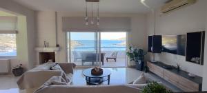 a living room with a view of the ocean at Villa Kapsali in Kythira