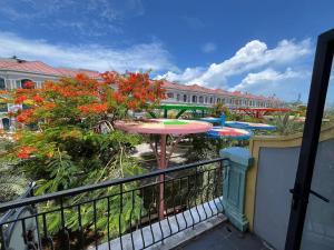 a balcony with a table and umbrellas at Arcadia homestay in Phú Quốc +24 photos