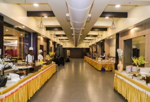 a dining hall with tables and people in a restaurant at Hotel Devanshi & Banquets by Classy Stay in Navi Mumbai