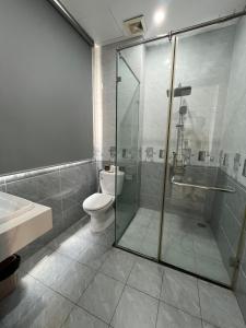 a bathroom with a shower and a toilet and a sink at Arcadia homestay in Phú Quốc