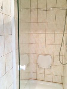 a bathroom with a glass shower with a toilet at Individuell Wohnen Loft-Charakter im Innenhof in Neuss +12 photos
