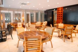 a dining room with wooden tables and chairs at Nature Resort in Kawamoto in Kawamoto