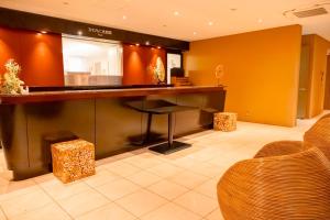 a bar in a lobby with a desk and chairs at Nature Resort in Kawamoto in Kawamoto