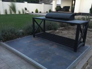 a black table with a grill on a patio at Boutique apartment Sky Nest in Uman