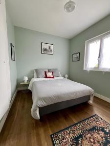 a bedroom with a bed and a rug at Maison David in Nantiat