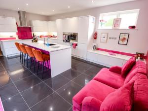 a kitchen and living room with a red couch at 105 Spilsby Road in Boston