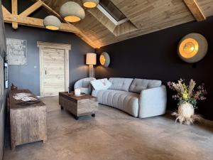 a living room with a couch and a table at Lodge Osciade in Sibret