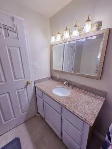 a bathroom with a sink and a mirror at Residence Tacoma in Tacoma +83 photos