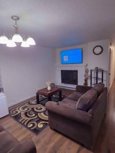 a living room with a couch and a flat screen tv at Residence Tacoma in Tacoma