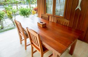 a wooden table with chairs and a wooden box at Leebong Island Resort in Leebong +66 photos