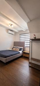 a bedroom with a bed in a room with a window at Nicholas Residence in Silang