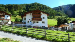 a house on a hill with a fence at Wastlhof in Malles Venosta