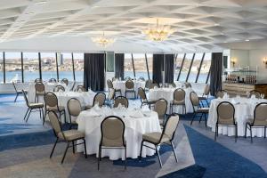 a banquet hall with white tables and chairs at Delta Hotels by Marriott Halifax Downtown in Halifax