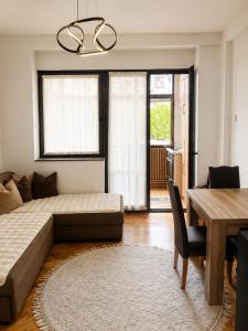 a bedroom with a bed and a table and a dining room at Ars Rooms in Prizren