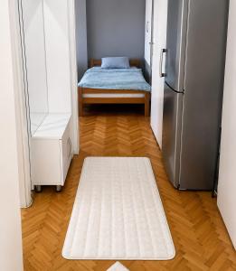 a room with a refrigerator and a bed in it at Ars Rooms in Prizren