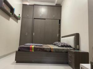 a bedroom with a bed and a mirror and cabinets at Cozy stay wsb in Wonosobo