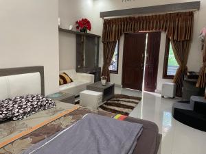 a living room with a bed and a couch at Cozy stay wsb in Wonosobo