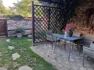a patio with a table and chairs and a fence at Family apartment Vysočina BIKE plus FUN in Nové Město na Moravě