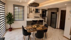 a kitchen and dining room with a table and chairs at Nicholas Residence in Silang