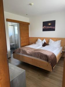a bedroom with a large bed with a wooden frame at Appartements Danijela in Fügenberg
