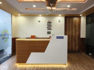 a reception desk in a room with a ceiling at Fng Guest House in Noida