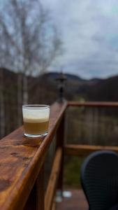 a glass of beer sitting on top of a wooden table at DnD Mountain Escape in Holbav