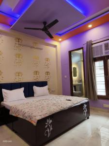 a bedroom with a bed with a purple ceiling at Fng Guest House in Noida