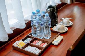 a wooden table with bottles of water on it at Leebong Island Resort in Leebong