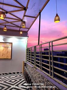 a balcony with a view of the city at sunset at Fng Guest House in Noida