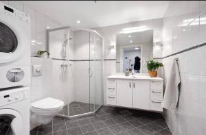 a bathroom with a shower and a toilet and a sink at Spacious apartment with amazing views in Sandnes
