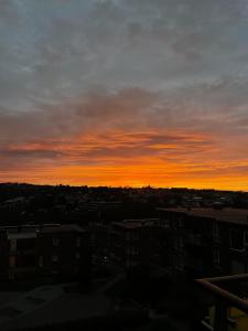 a sunset over a city with buildings and buildings at Spacious apartment with amazing views in Sandnes