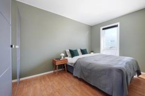 a bedroom with a large bed and a window at Spacious apartment with amazing views in Sandnes