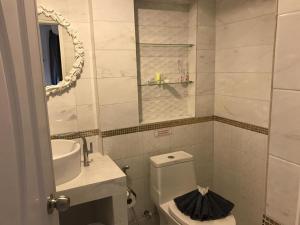 a bathroom with a toilet and a sink and a mirror at white house in Phangnga +30 photos