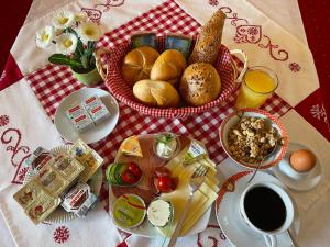 a breakfast table with a basket of bread and a cup of coffee at Haus Bodenwinkler in Gröbming +38 photos