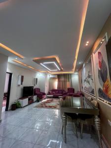 a living room with a couch and a table at عماره in Sheikh Zayed