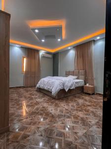 a bedroom with a large bed in a room at عماره in Sheikh Zayed +3 photos